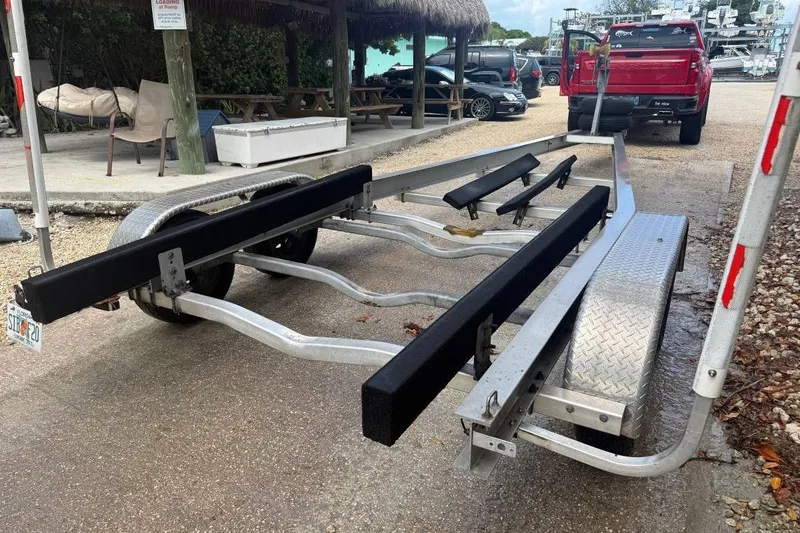 Slide: The Image of Boat trailer parked near a red truck, suitable for Grady-White Advance 247, 1996 model. - 4