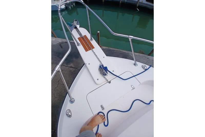 Slide: The Image of Bow of 1996 Grady-White Advance 247 boat with anchor and blue rope. - 44