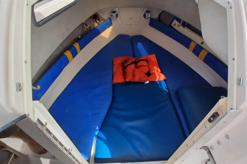 Slide: The Image of Interior cabin of a 1996 Grady-White Advance 247 boat with blue cushions and life jacket. - 48