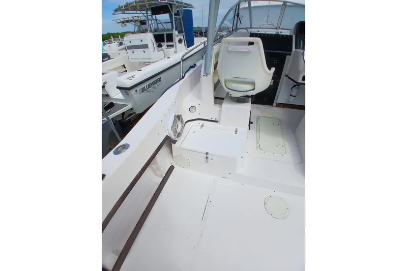 Slide: The Image of 1996 Grady-White Advance 247 boat interior with seating and control panel. - 6
