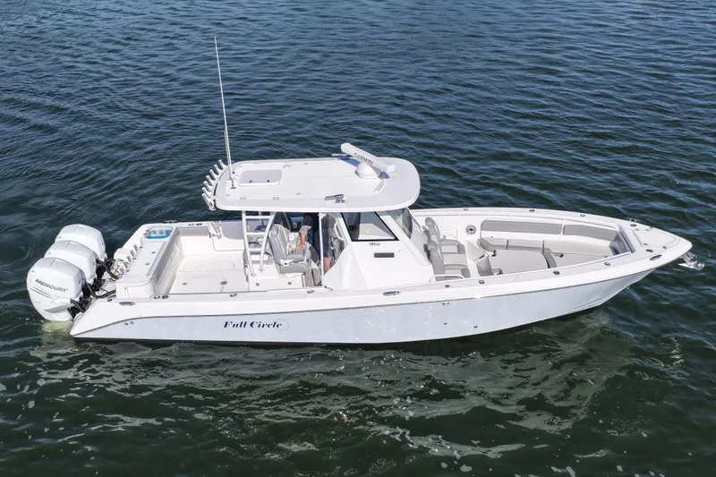 Slide: The Image of 2022 Everglades 365 Center Console boat on water, featuring sleek design and twin Mercury engines. - 13
