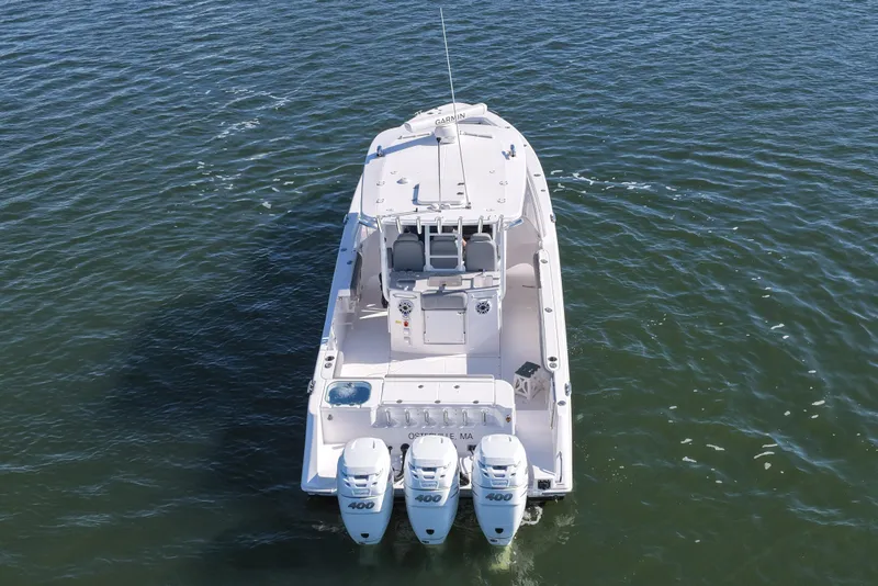 Slide: The Image of 2022 Everglades 365 Center Console boat with triple 400 horsepower engines on open water. - 14