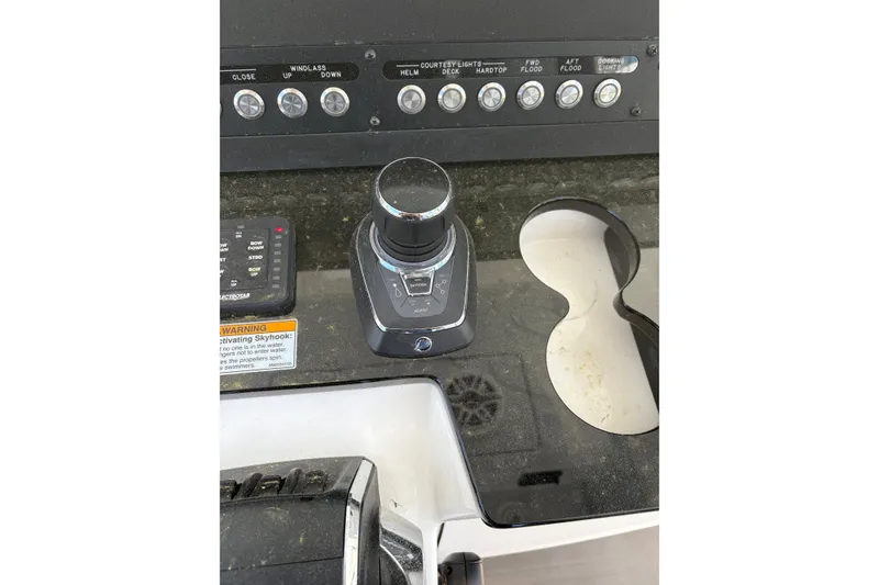 Slide: The Image of Control panel of 2022 Everglades 365 Center Console boat with joystick and switches. - 21
