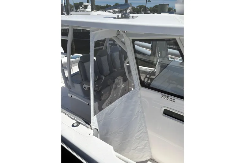 Slide: The Image of 2022 Everglades 365 Center Console boat with protective cover and seating area. - 35