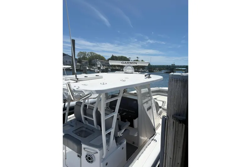 Slide: The Image of 2022 Everglades 365 Center Console boat docked under clear blue sky. - 37