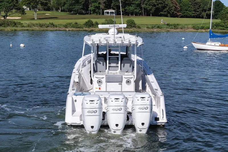 Slide: The Image of 2022 Everglades 365 Center Console boat with triple 400 engines on a serene lake. - 4