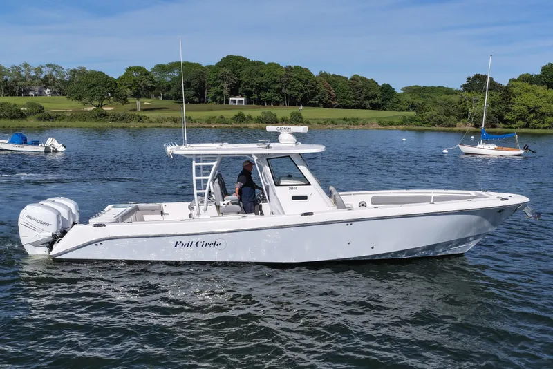 Slide: The Image of 2022 Everglades 365 Center Console boat on a scenic lake with trees in the background. - 8