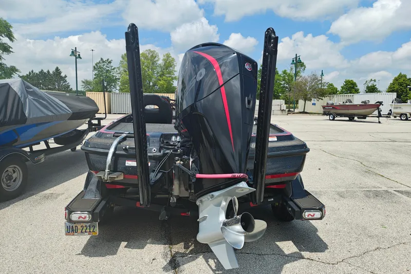 Slide: The Image of 2022 Nitro Z21 XL Pro boat with powerful outboard motor in a parking lot. - 11