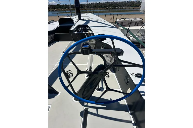 Slide: The Image of Steering wheel of a 2018 Botin 56 yacht, featuring a sleek blue design. - 18