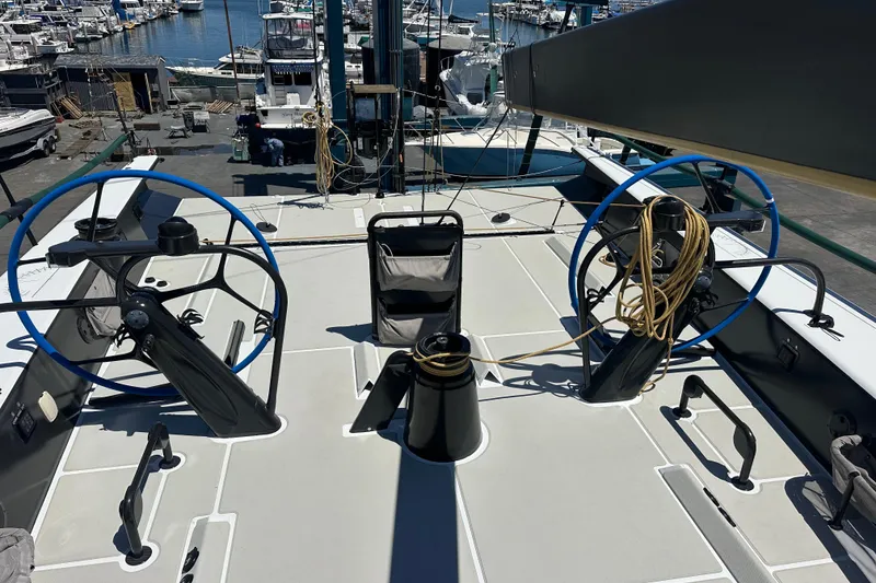 Slide: The Image of Deck view of a 2018 Botin 56 yacht with dual steering wheels at a marina. - 20