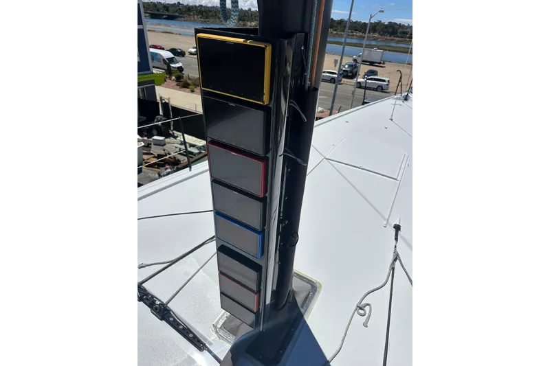Slide: The Image of Sailing yacht Botin 56 (2018) mast with colorful display panels, dockside view. - 22