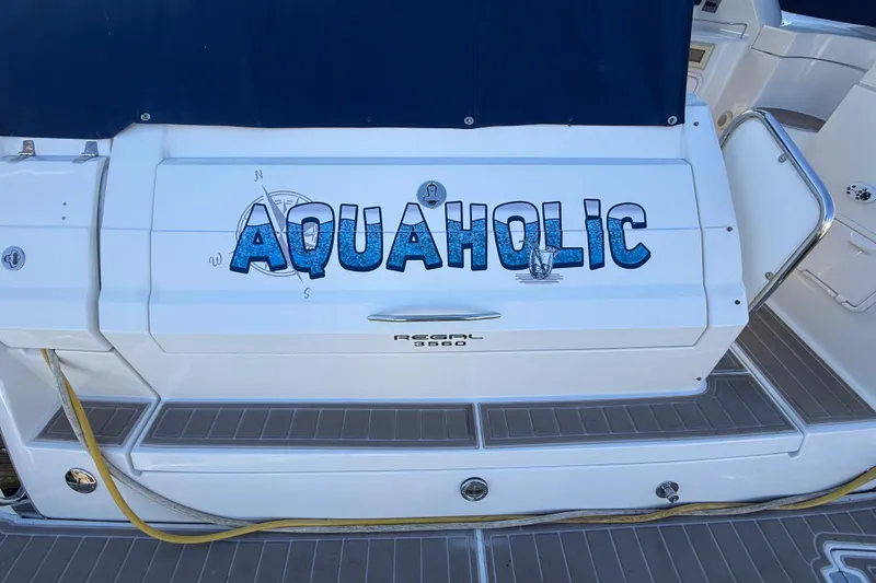 Slide: The Image of 2005 Regal Commodore 3560 IO boat with "Aquaholic" name on the stern. - 10