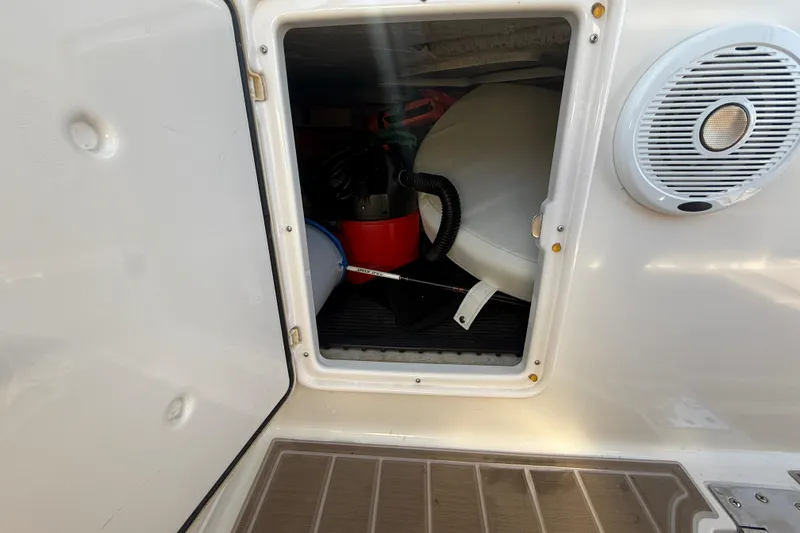 Slide: The Image of Storage compartment on a 2005 Regal Commodore 3560 IO boat, featuring various equipment. - 19