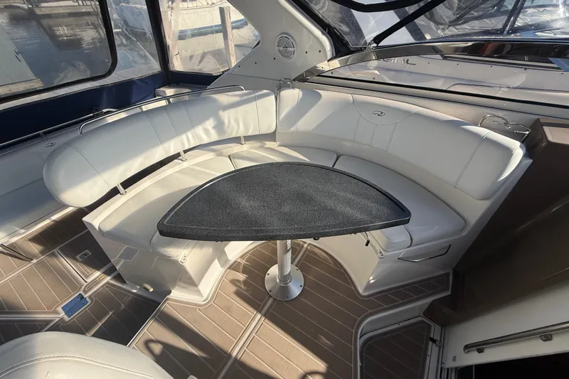 Slide: The Image of Interior of 2005 Regal Commodore 3560 IO yacht with white seating and a black table. - 27