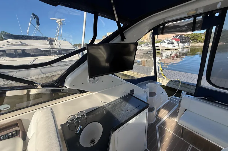 Slide: The Image of Interior of 2005 Regal Commodore 3560 IO yacht with sink and mounted TV. - 29