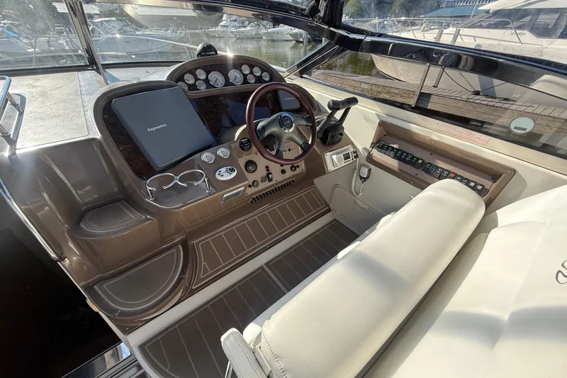Slide: The Image of Cockpit of 2005 Regal Commodore 3560 IO boat with steering wheel and control panel. - 31