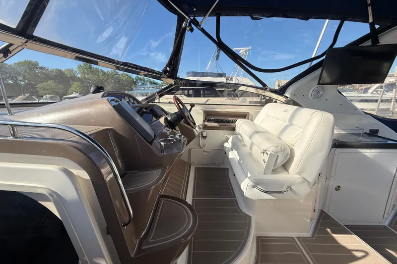 Slide: The Image of Interior view of 2005 Regal Commodore 3560 IO boat cockpit with steering and seating. - 32