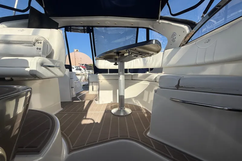 Slide: The Image of Interior of 2005 Regal Commodore 3560 IO yacht with seating and table, docked at marina. - 40