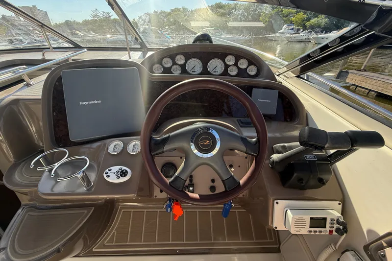Slide: The Image of Cockpit of 2005 Regal Commodore 3560 IO with steering wheel, gauges, and Raymarine displays. - 41