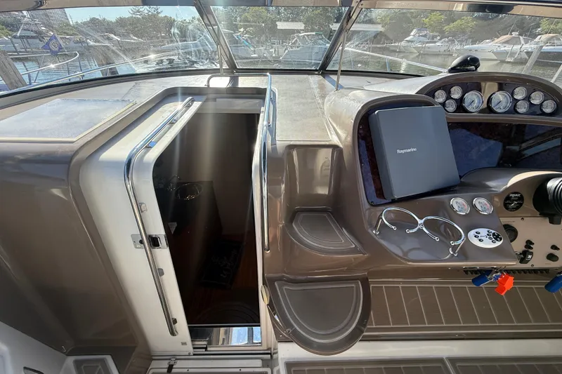 Slide: The Image of 2005 Regal Commodore 3560 IO cockpit with navigation equipment and cabin entrance. - 42