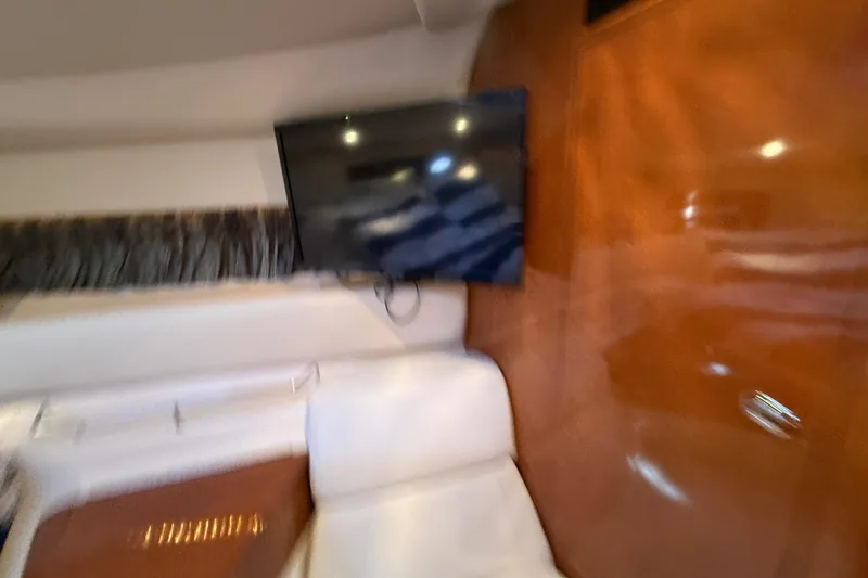 Slide: The Image of Interior of 2005 Regal Commodore 3560 IO with TV and wooden paneling. - 62