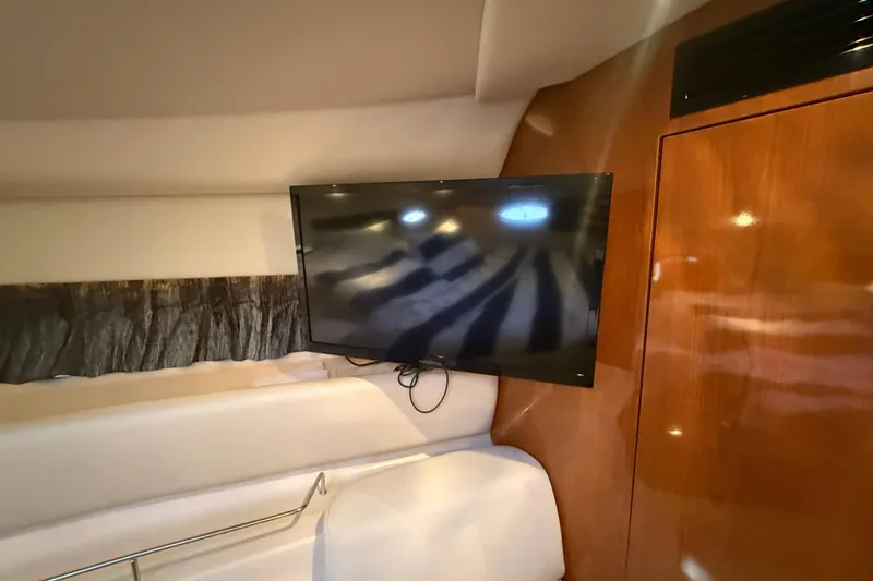 Slide: The Image of Interior of 2005 Regal Commodore 3560 IO yacht with mounted flat-screen TV. - 63