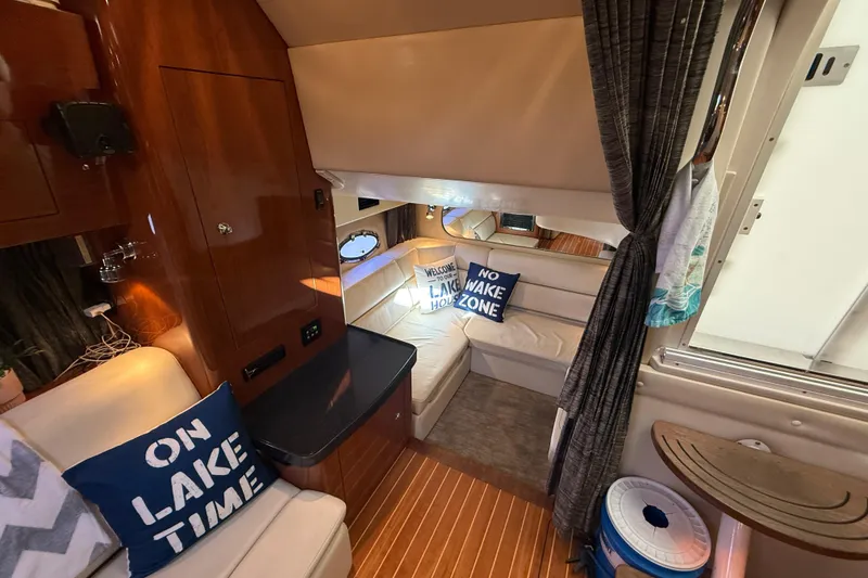 Slide: The Image of Interior of 2005 Regal Commodore 3560 IO boat with cozy seating and nautical decor. - 68