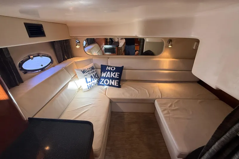 Slide: The Image of Interior of 2005 Regal Commodore 3560 IO yacht with cozy seating and nautical pillows. - 69