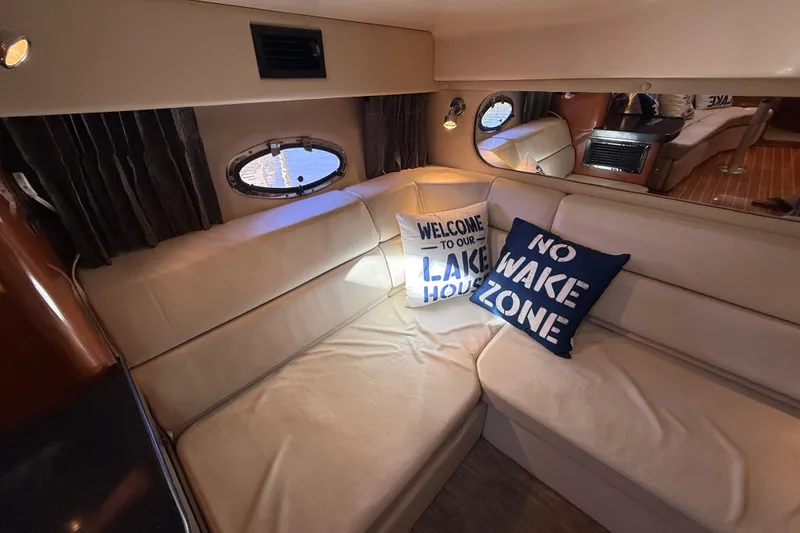 Slide: The Image of Interior of 2005 Regal Commodore 3560 IO with cozy seating and decorative pillows. - 71