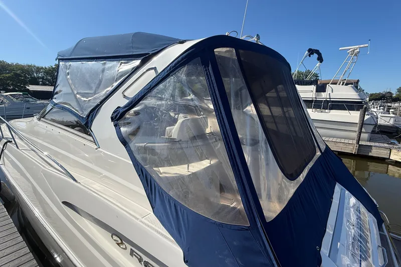 Slide: The Image of 2005 Regal Commodore 3560 IO boat with blue canopy docked at marina. - 8