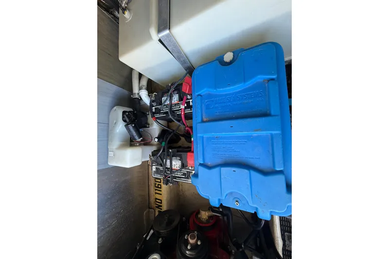 Slide: The Image of Engine compartment of a 2005 Regal Commodore 3560 IO boat, featuring battery systems. - 84