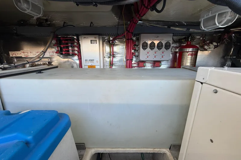 Slide: The Image of Engine compartment of a 2005 Regal Commodore 3560 IO with electrical components and wiring. - 85