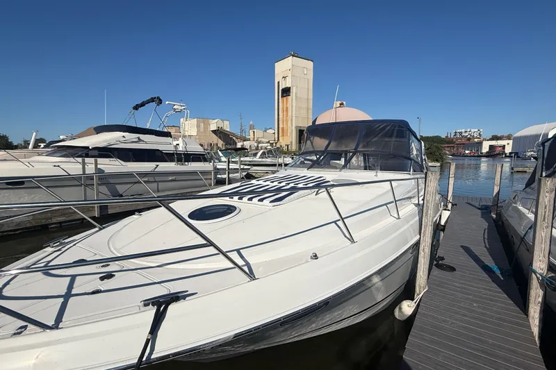Slide: The Image of 2005 Regal Commodore 3560 IO yacht docked at marina under clear blue sky. - 9