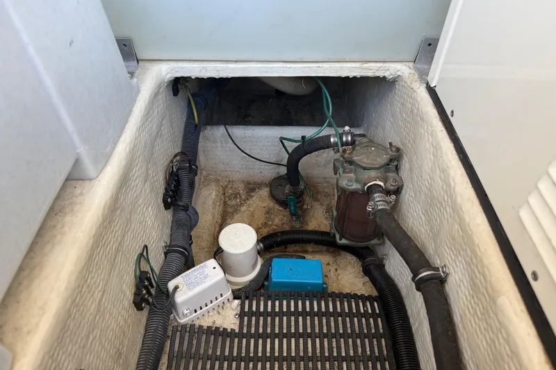 Slide: The Image of Bilge area of a 2005 Regal Commodore 3560 IO boat, showing pump and wiring. - 90