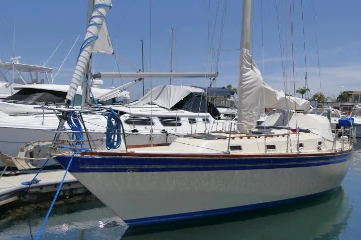 Slide: The Image of 1978 Tartan 37 sailboat docked in a marina under clear blue skies. - 1