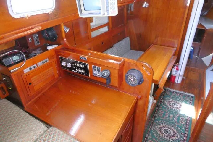 Slide: The Image of Interior of a 1978 Tartan 37 sailboat with wooden furnishings and navigation equipment. - 19