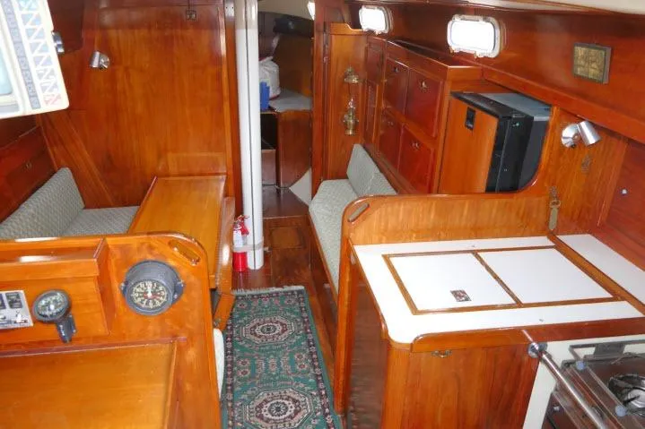 Slide: The Image of Interior of a 1978 Tartan 37 sailboat with wooden cabinetry and seating. - 2