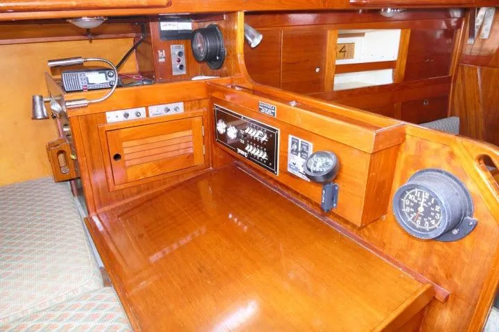Slide: The Image of 1978 Tartan 37 yacht interior with navigation equipment and wooden cabinetry. - 20