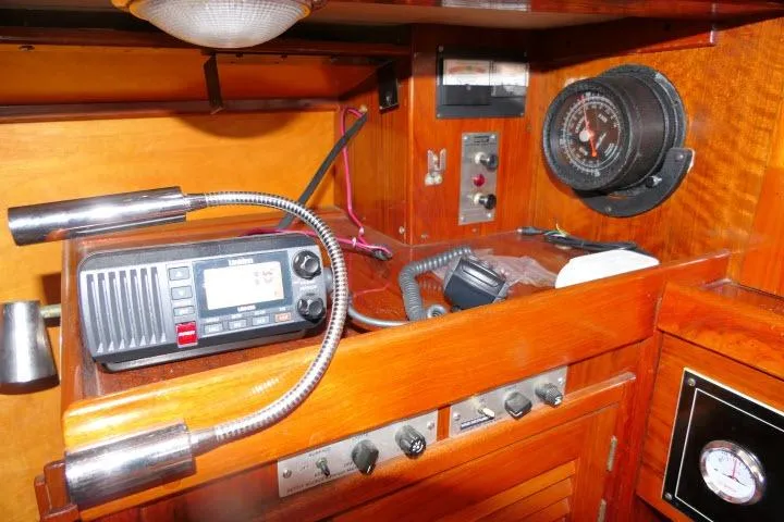 Slide: The Image of Interior of a 1978 Tartan 37 sailboat featuring navigation equipment and wooden cabinetry. - 21