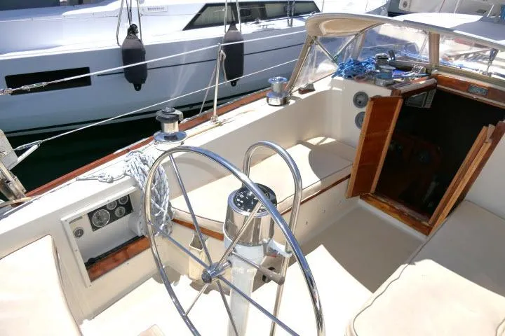 Slide: The Image of Cockpit of a 1978 Tartan 37 sailboat with steering wheel and cabin entrance. - 27
