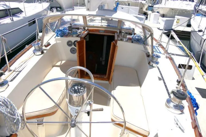 Slide: The Image of Cockpit of a 1978 Tartan 37 sailboat with steering wheel and seating. - 28