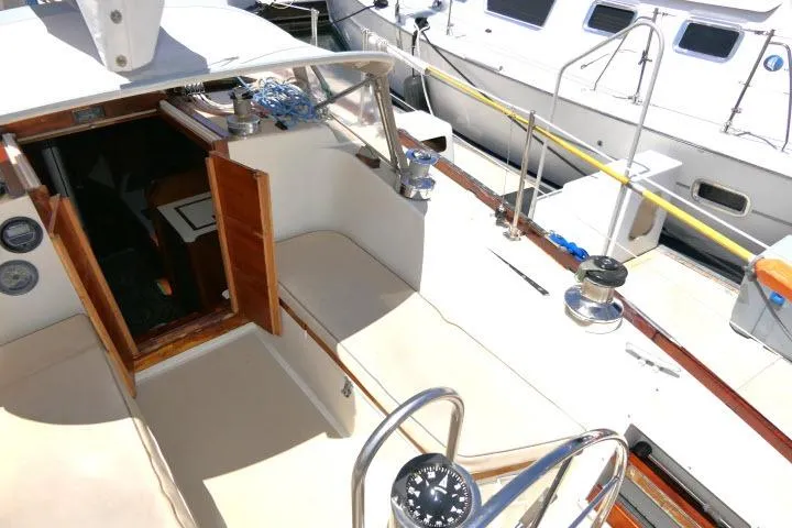 Slide: The Image of Cockpit view of a 1978 Tartan 37 sailboat, showcasing seating and navigation equipment. - 29