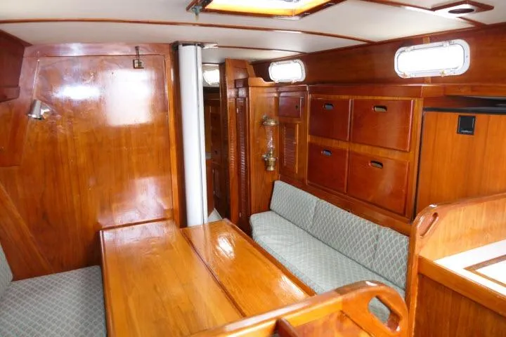 Slide: The Image of Interior of a 1978 Tartan 37 sailboat with polished wood and cozy seating. - 3