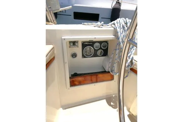 Slide: The Image of 1978 Tartan 37 sailboat cockpit with control panel and nautical ropes. - 32