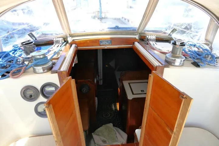 Slide: The Image of Interior view of a 1978 Tartan 37 sailboat, featuring wooden cabin doors and nautical equipment. - 34