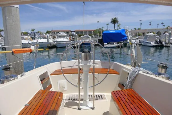 Slide: The Image of Cockpit view of a 1978 Tartan 37 sailboat docked in a marina. - 35