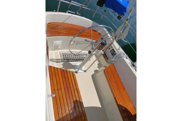 Slide: The Image of 1978 Tartan 37 sailboat cockpit with wooden seating and steering wheel. - 36