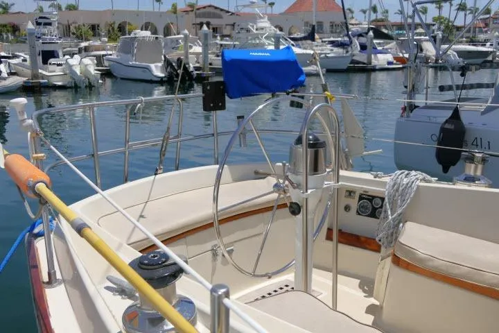 Slide: The Image of Cockpit of a 1978 Tartan 37 sailboat docked in a marina with other boats. - 38