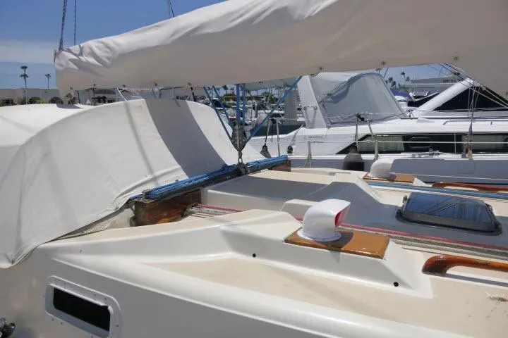 Slide: The Image of 1978 Tartan 37 sailboat with covered cockpit, docked in a marina under clear skies. - 40