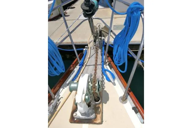 Slide: The Image of Bow of 1978 Tartan 37 sailboat with anchor chain and blue ropes. - 45
